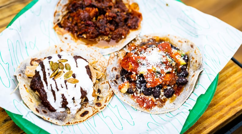Tacos from Supremo include (clockwise from top) al pastor, black bean and mole poblano. CONTRIBUTED BY HENRI HOLLIS