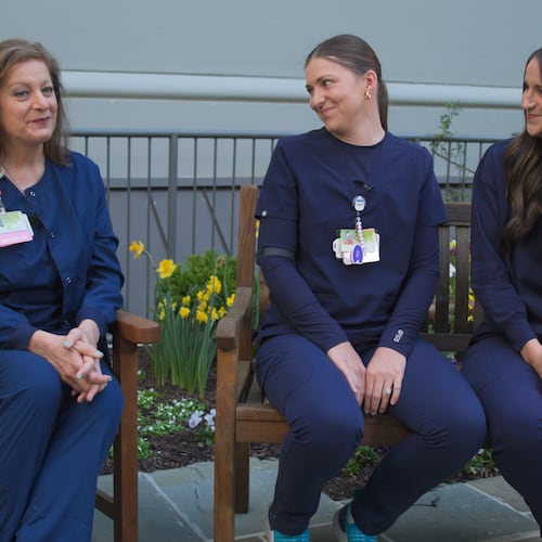 Sarah Rushton (left) sits with twin daughters, McKenna Roberts (center) and Mary Kate Harris, who are also nurses at Northeast Georgia Medical Center in Gainesville. Sarah gave birth to the twins at the hospital, where Sarah has spent 42 years and the twins have worked 10 years bringing new babies into the world. (Courtesy of Northeast Georgia Medical Center)
