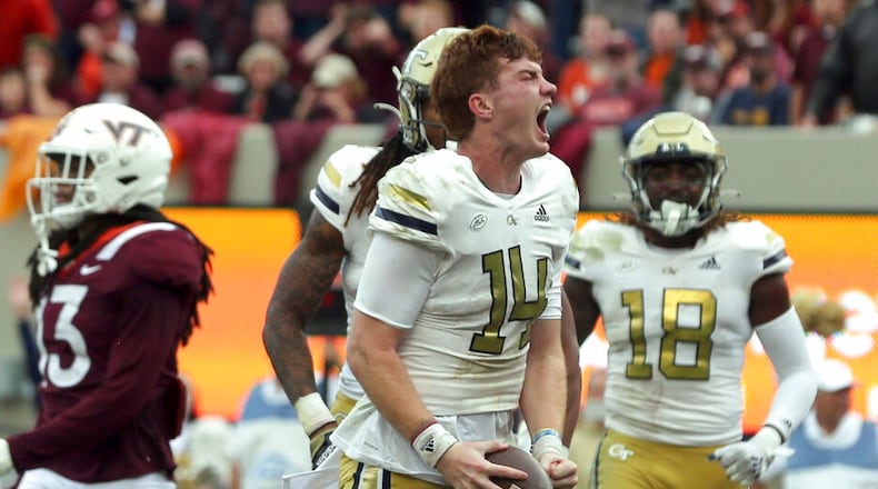 Georgia Tech quarterback Zach Pyron (14) celebrates a touchdown run in the second half of an NCAA college football game against Virginia Tech, Saturday, Nov. 5 2022, in Blacksburg, Va. (Matt Gentry/The Roanoke Times via AP)