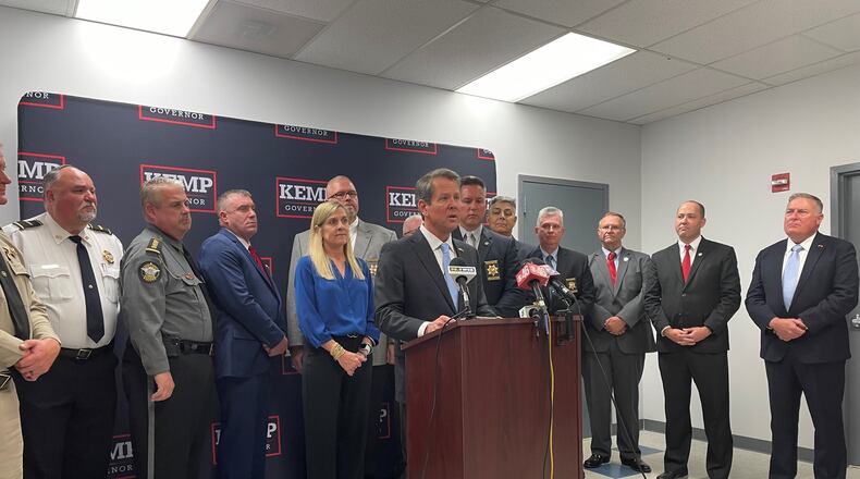 Gov. Brian Kemp campaigns with his wife Marty and about a dozen law enforcement officers.