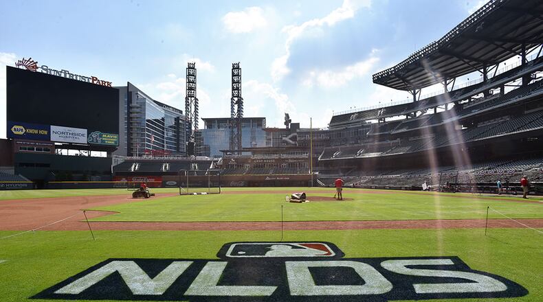 The grounds crew works on the SunTrust Park field a day before Thursday's Game 1 of the best-of-five National League Division Series between the Braves and St. Louis Cardinals . (Hyosub Shin / Hyosub.Shin@ajc.com)