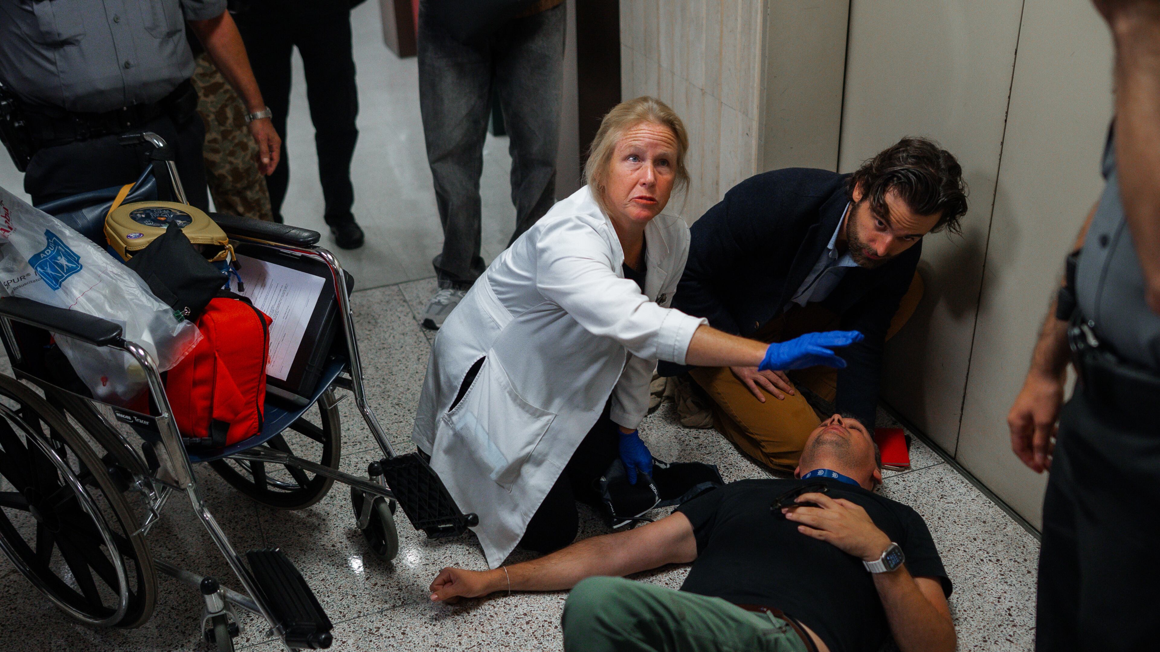 Journalist L. Vural Elibol receives medical assistance after being shoved by federal agents in immigration court on Tuesday, Sept. 30, 2025, in New York. (AP Photo/Olga Fedorova)
