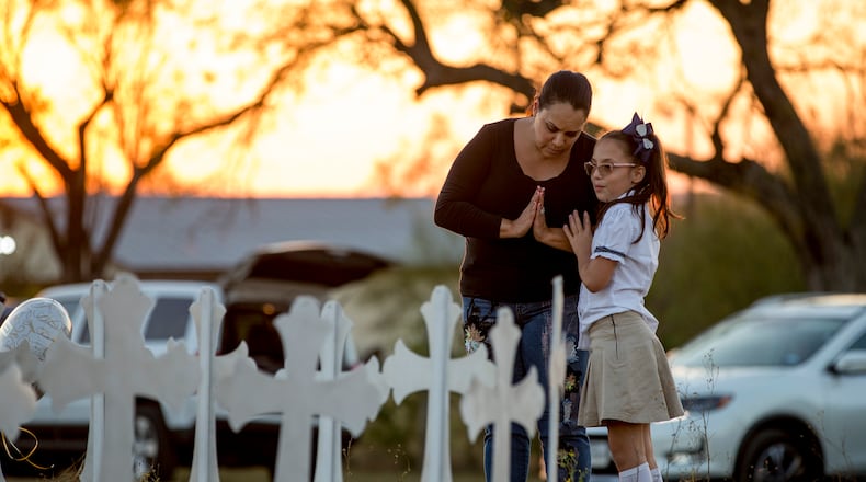 USE THIS LEDE INSIDEMeredith Cooper, of San Antonio, and her eight-year-old daughter, Heather, visit a memorial of 26 metal crosses near First Baptist Church in Sutherland Springs on Monday November 6, 2017.  JAY JANNER / AMERICAN-STATESMAN