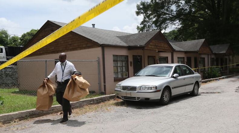 Homicide investigators collect evidence at the scene of shooting involving a 4-year-old boy on Tuesday, July 14, 2015. BEN GRAY / BGRAY@AJC.COM