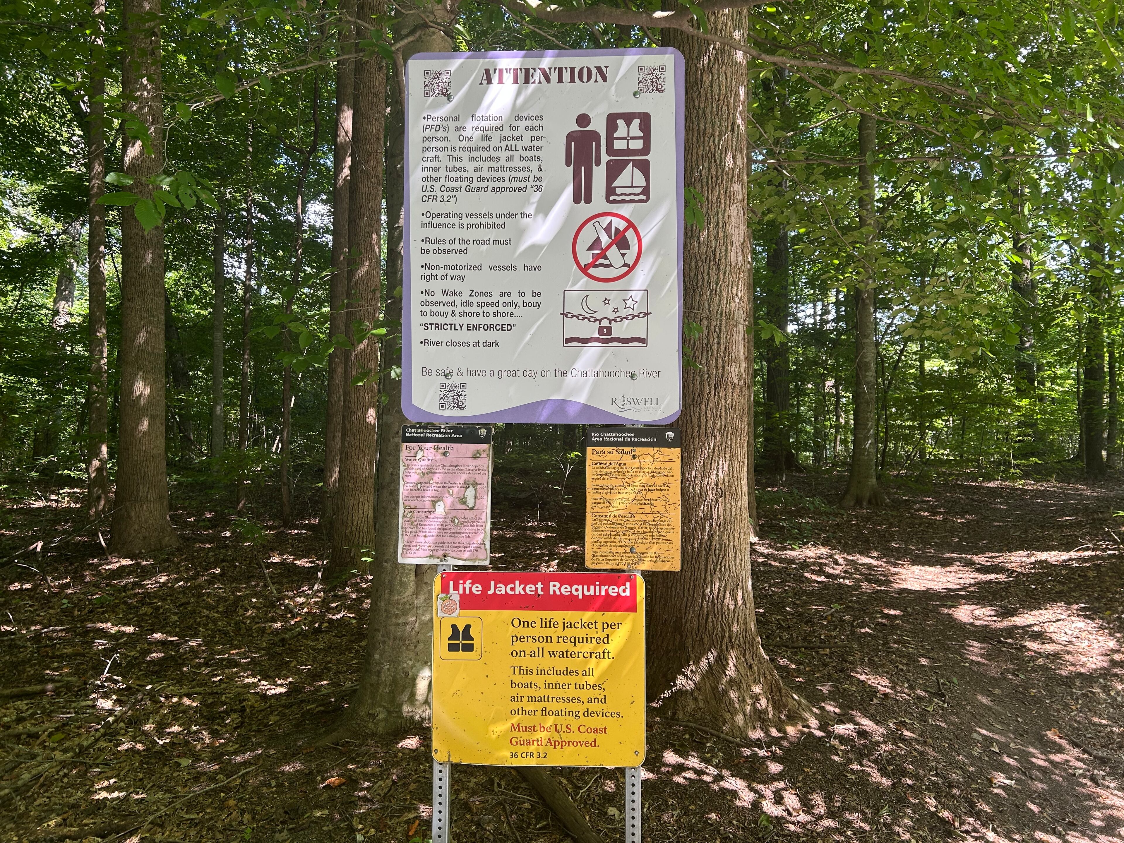 Signs warn visitors at Garrard Landing Park in Roswell. (Thomas Lake/AJC)