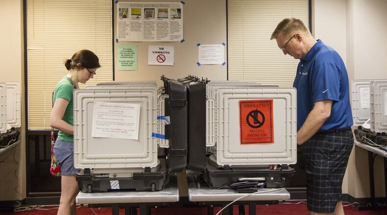 People cast their vote during early voting in May at the Dunwoody Public Library. (REANN HUBER/REANN.HUBER@AJC.COM)