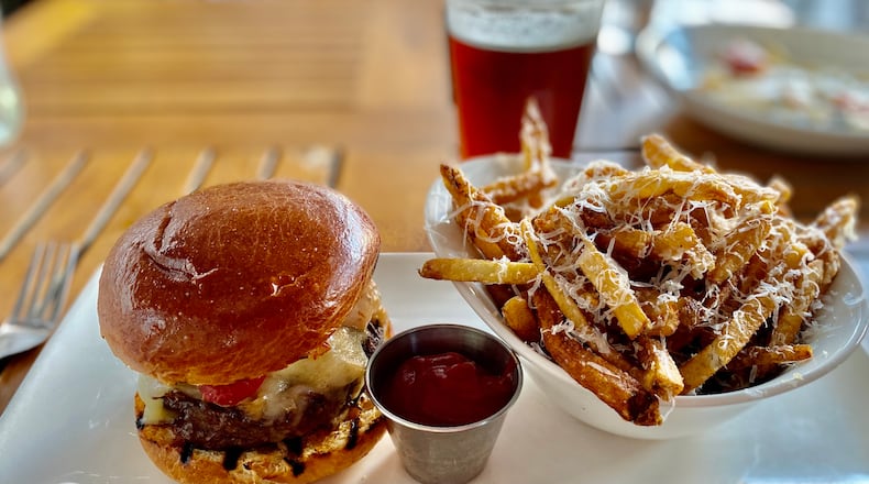 Seed Kitchen & Bar serves a terrific burger; shown here with Parmesan fries. (Wendell Brock for The Atlanta Journal-Constitution)