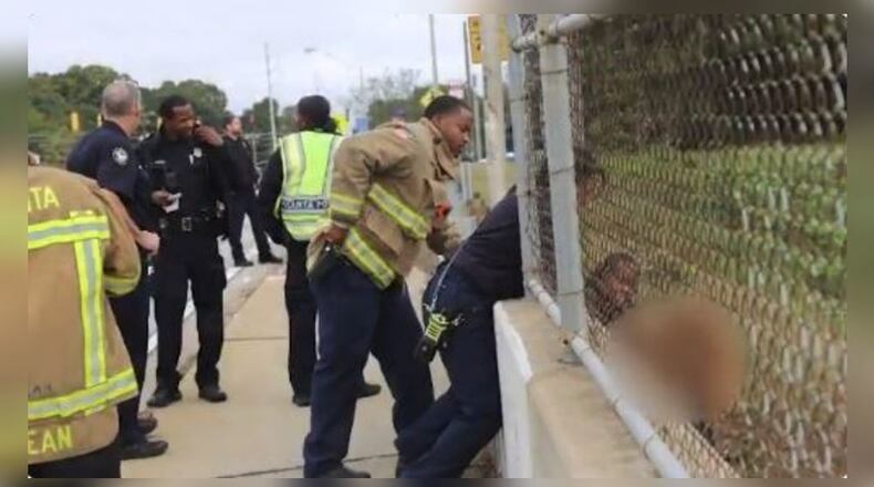Atlanta police work to rescue woman during suicide attempt.
