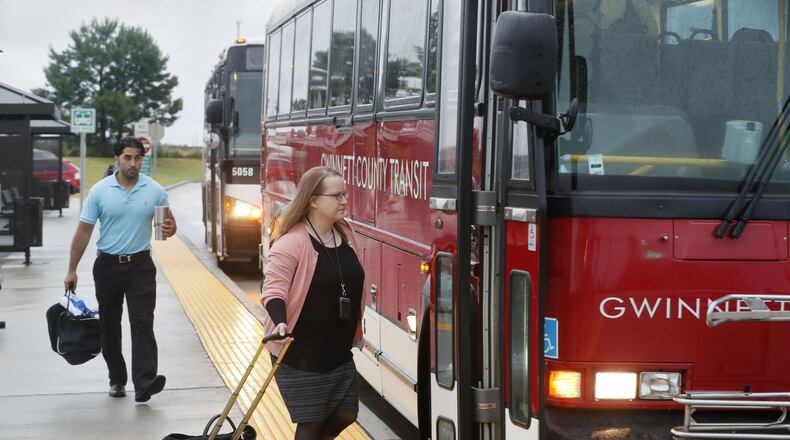 Commuters board Gwinnett County Transit express buses departing for downtown Atlanta at the Express Bus Park and Ride lot at Sugarloaf Mills in Lawrenceville. BOB ANDRES /BANDRES@AJC.COM