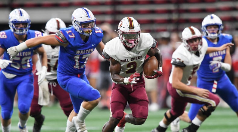 August 20 , 2022 Atlanta - Mill Creek's Caleb Downs (2) runs for a touchdown during the 2022 Corky Kell Classic at Mercedes Benz Stadium on Saturday, August 20, 2022. Downs has an NIL value of $315,000, according to On3.com, an online recruiting service launched by Rivals and 247Sports founder Shannon Terry. (Hyosub Shin / Hyosub.Shin@ajc.com)