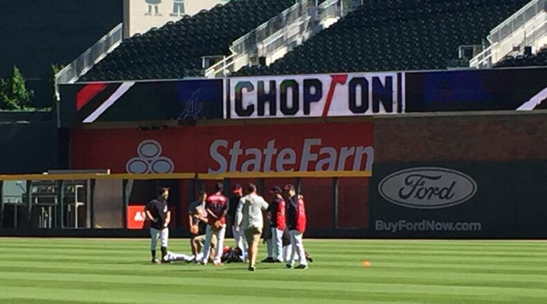 Anibal Sanchez is surrounded by trainers and teammates after he was injured running sprints Wednesday at SunTrust Park. (Gabe Burns / AJC)