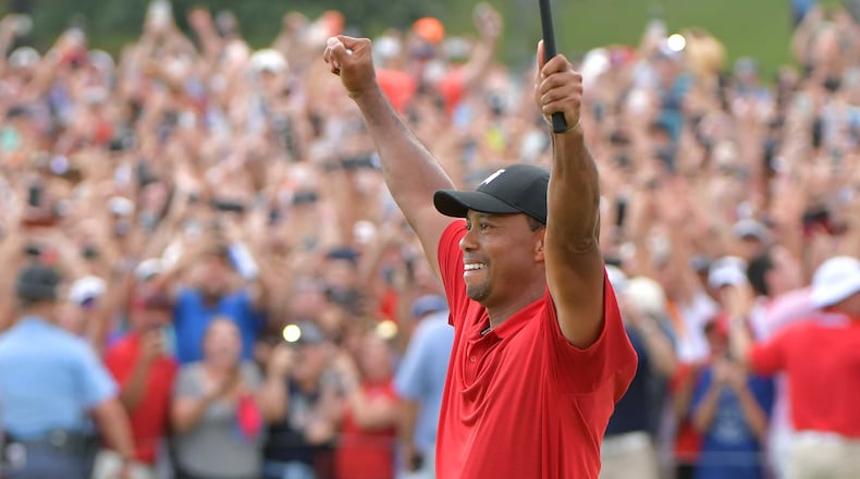 Tiger Woods celebrates as he wins the TOUR Championship on the 18th green during the final round of the TOUR Championship at East Lake Golf Club on Sunday, September 23, 2018.