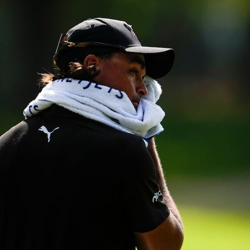 Rickie Fowler wipes his face in the heat off the fifth tee box during the first round of the St. Jude Championship golf tournament, Thursday, Aug. 13, 2026, in Memphis, Tenn. (AP Photo/George Walker IV)
