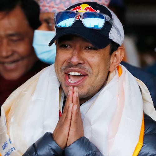 FILE - Nirmal Purja, one of the team member of the all-Nepalese mountaineering team that became the first to scale Mount K2 in winter, gestures as the team arrives at Tribhuwan International airport in Kathmandu, Nepal, Jan. 26, 2021. (AP Photo/Niranjan Shrestha, File)