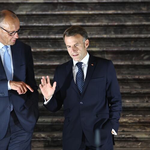 German Chancellor Friedrich Merz, left, talks with French President Emmanuel Macron as they arrive for a press conference following a meeting of the Franco-German Ministerial Council in Brühl, Germany, Friday, July 17, 2026. (Oliver Berg/dpa via AP)