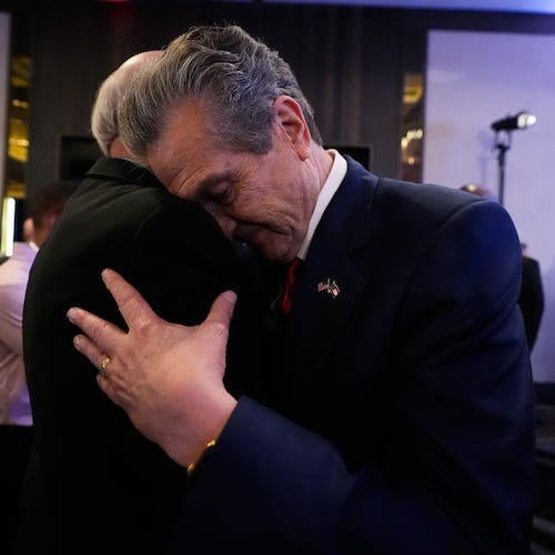 Georgia gubernatorial candidate Rick Jackson is hugged by a supporter after speaking during a primary election night party on Tuesday, May 19, 2026, in Atlanta. (AP Photo/Brynn Anderson)