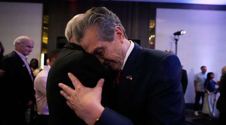 Georgia gubernatorial candidate Rick Jackson is hugged by a supporter after speaking during a primary election night party on Tuesday, May 19, 2026, in Atlanta. (AP Photo/Brynn Anderson)