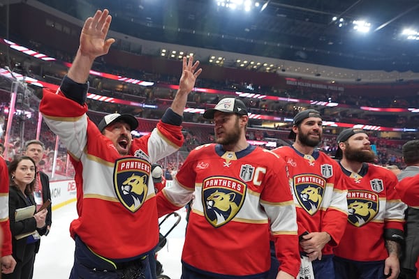 Florida Panthers center Brad Marchand and captain Aleksander Barkov celebrate after defeating the Edmonton Oilers in Game 6 of the NHL hockey Stanley Cup Final Tuesday, June 17, 2025, in Sunrise, Fla. (AP Photo/Lynne Sladky)
