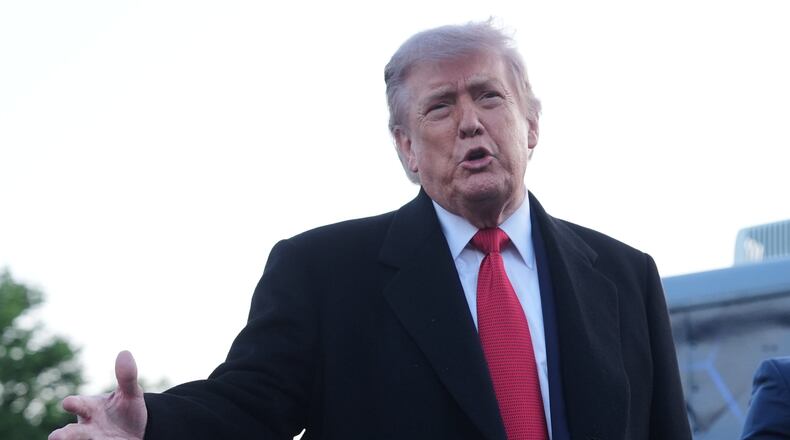 President Donald Trump speaks as he visits the Lincoln Memorial Reflecting Pool to see the new blue protective coating being applied as part of a renovation project, Thursday, May 7, 2026, in Washington. (AP Photo/Mark Schiefelbein)