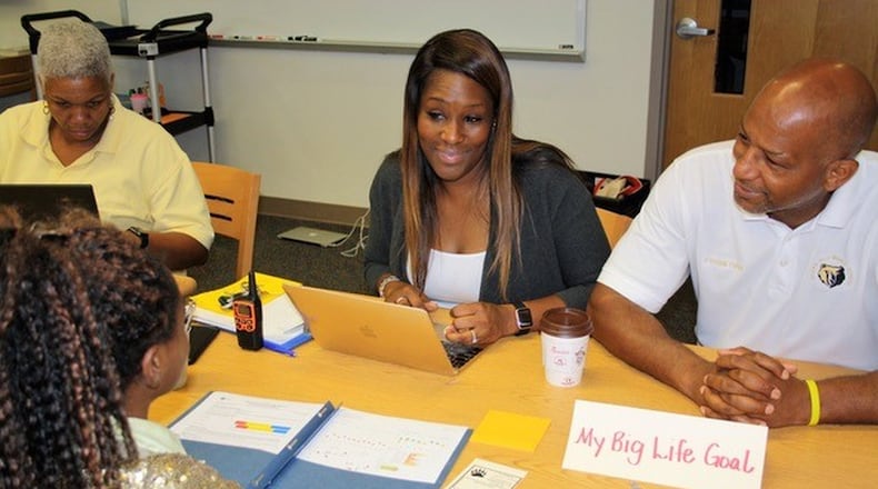 Sylvan Hills Middle School Assistant Principal Monica Blasingame, center, and Principal Artesza Portee, right, discuss big life goals with a student as part of a goal-setting exercise in Atlanta Public Schools. Tara García Mathewson/The Hechinger Report