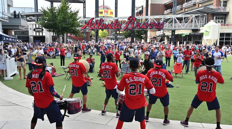 Getting fired up for Game 4: The Heavy Hitters drumline entertains baseball fans at The Battery Atlanta Tuesday prior to Game 4 of the National League Divisional Series between the Braves and Brewers.