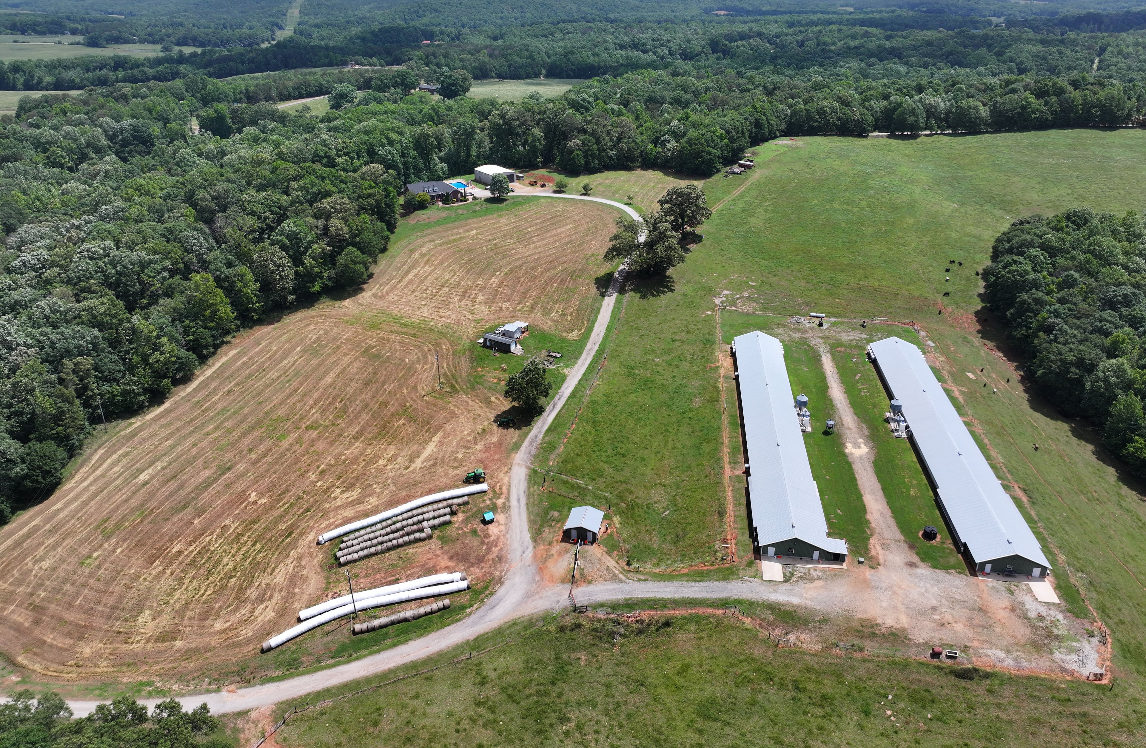 Aerial photo shows the property of Banks County Sheriff Carlton Speed, Wednesday, May 21, 2025, in Carnesville. The boundary between Banks and Franklin mysteriously moved to the east, allowing the Banks sheriff to claim he lives in the county and keep his job as the top lawman. The boundary between Banks and Franklin runs between his residency (background) and his chicken farm (foreground). (Hyosub Shin / AJC)