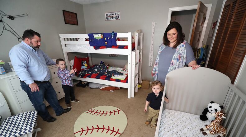 031521 Cartersville: Melanie and Kris Lambert and their sons Connor, 5, and Harrison, 2, prepare the boy’s room for the birth of their third son Hank, who will be taking over Harrison’s crib while he moves to the bunk beds at the family home on Monday, March 15, 2021, in Cartersville. Curtis Compton / Curtis.Compton@ajc.com