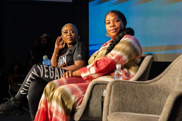 Pinky Cole (left), Founder of Slutty Vegan, and Jasmine Crowe Houston (center), CEO and founder of Goodr, prepare to speak on a panel for Black business owners at the Gathering Spot in Atlanta on Tuesday, Aug. 27, 2024. (Olivia Bowdoin for the AJC)