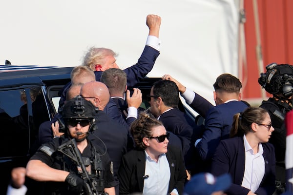 FILE - Republican presidential candidate former President Donald Trump is escorted to a motorcade following an attempted assassination at a campaign event in Butler, Pa., July 13, 2024. (AP Photo/Gene J. Puskar, File)