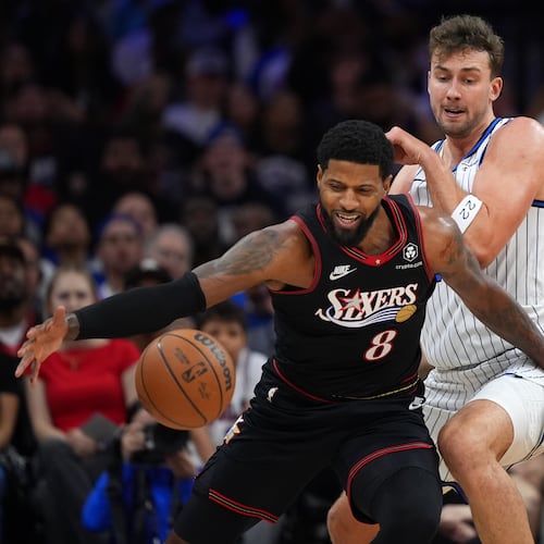 Philadelphia 76ers' Paul George, left, tries to get past Orlando Magic's Franz Wagner during the first half of an NBA play-in tournament basketball game Wednesday, April 15, 2026, in Philadelphia. (AP Photo/Matt Slocum)