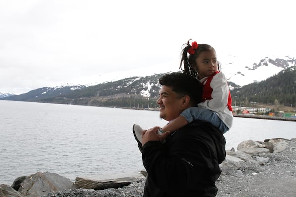 Michael Pese and his daughter Cataleya survey Blackstone Bay in Whittier, Alaska, May 13, 2025. (AP Photo/Mark Thiessen)
