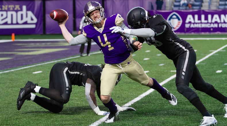 Atlanta Legends quarterback Matt Simms is chased down by Birmingham Iron's Devin Taylor during Legends home opener Sunday, Feb. 24, 2019, at Georgia State Stadium. Atlanta lost 28-12.