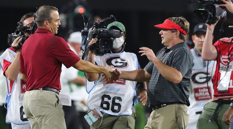 Considering his background – starting with his dad – it would be hard to call Shane Beamer (left) a part of Kirby Smart’s coaching tree. But he credits the Georgia coach and his time in Athens for a lot of what he’s trying to implement at South Carolina. (Curtis Compton / Curtis.Compton@ajc.com)