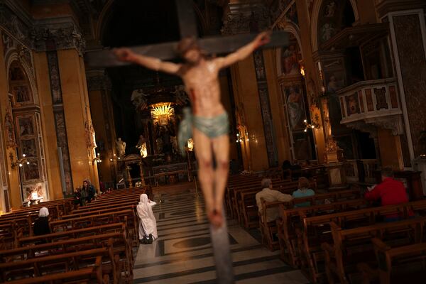 A nun prays in the Church of Santa Maria in Traspontina, outside the Vatican,Tuesday, April 22, 2025. (AP Photo/Francisco Seco)