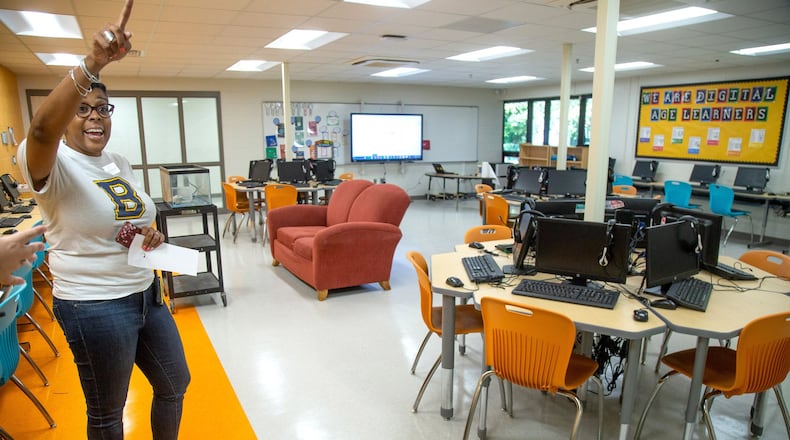 Beecher Hills Elementary school principal Crystal Jones talks to families in the schools’ new computer lab at the first open house after the schools’ extensive renovation Friday, August 9, 2019. STEVE SCHAEFER / SPECIAL TO THE AJC