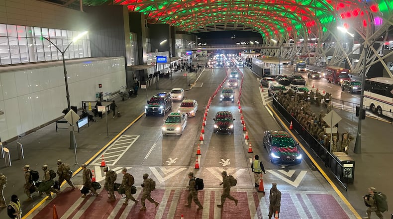 Holiday travelers are filling Hartsfield-Jackson International Airport, with troops and other travelers streaming into the terminal on Monday, December 18, 2023.