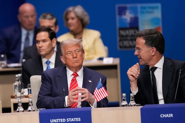 President Donald Trump and NATO Secretary General Mark Rutte, right, attend a plenary session at the NATO summit in The Hague, Netherlands, Wednesday, June 25, 2025. (AP Photo/Matthias Schrader)