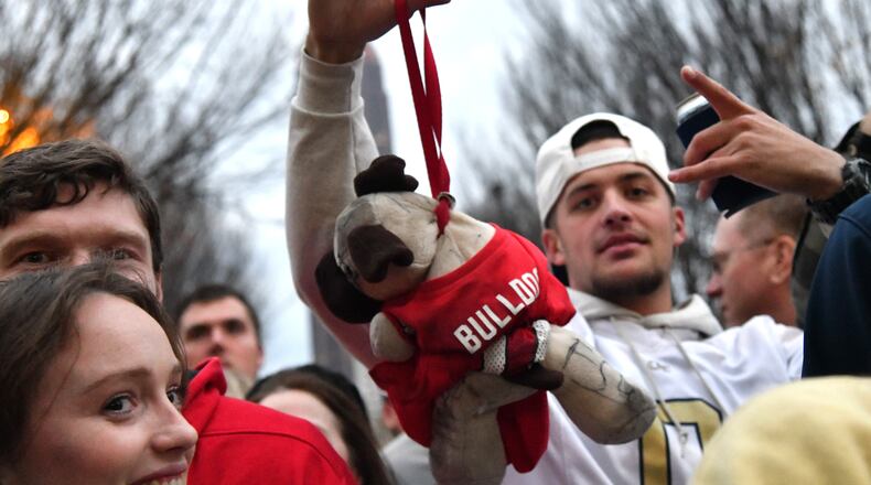 Georgia Tech fan holds a bulldog dog as he cheers during Block Party prior to an NCAA college football game between Georgia Tech and Georgia at Georgia Tech's Bobby Dodd Stadium, Saturday, November 25, 2023, in Atlanta. (Hyosub Shin / Hyosub.Shin@ajc.com)