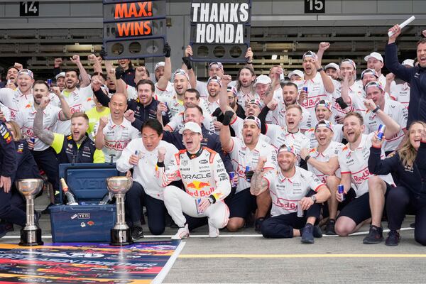 Red Bull driver Max Verstappen of the Netherlands celebrates with his crew after the Japanese Formula One Grand Prix at the Suzuka Circuit in Suzuka, central Japan, Sunday, April 6, 2025. (AP Photo/Hiro Komae)