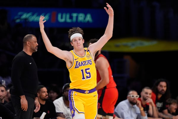 Los Angeles Lakers guard Austin Reaves celebrates after hitting a three-point shot during the first half of an NBA basketball game against the Houston Rockets, Friday, April 11, 2025, in Los Angeles. (AP Photo/Mark J. Terrill)