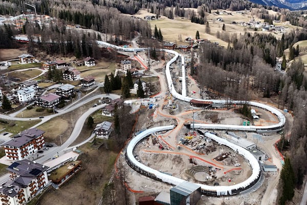 Construction work takes place at the Cortina Sliding Center, venue for the bob, luge and skeleton disciplines at the Milan Cortina 2026 Winter Olympics, in Cortina D'Ampezzo, Italy, Tuesday, March 25, 2025. (AP Photo/Luca Bruno)