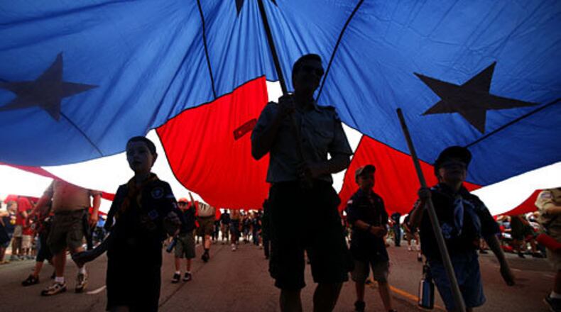 Boy Scouts of America and Cub Scout troops carry a large American flag during the LibertyFest Fourth of July parade in Edmond, Okla.