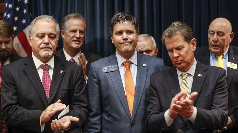 Feb. 4, 2020 - Atlanta - State school Superintendent Richard Woods and Gov. Brian Kemp applaud after Kemp announced legislation Tuesday to “reduce high-stakes K-12 testing in Georgia.” (Bob Andres / AJC file photo)