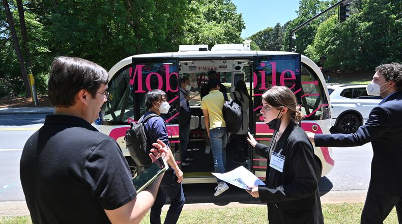 May 12, 2022 Peachtree Corners - Guests get on an autonomous shuttle for a test ride at Curiosity Lab shuttle stop in Peachtree Corners on Thursday, May 12, 2022. On Thursday May 12, top automakers, technology companies and carriers are coming together at the Curiosity Lab in Peachtree Corners and Applied Information in Alpharetta for live demos as part of the 5G Automotive Association (5GAA) conference. (Hyosub Shin / Hyosub.Shin@ajc.com)
