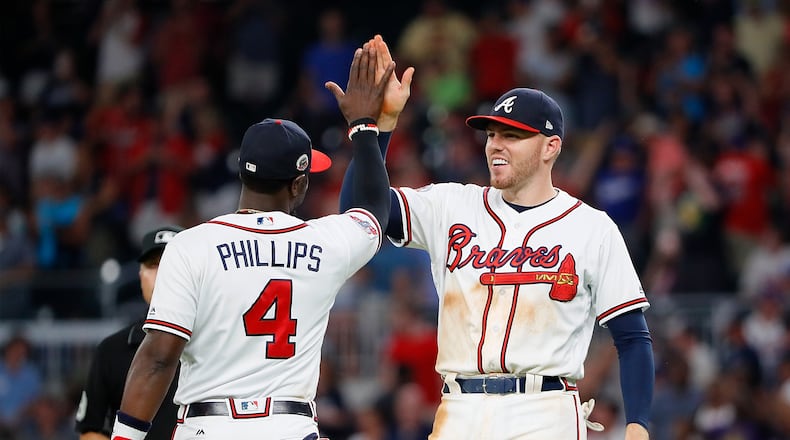 A meeting of noted Braves third basemen breaks out, post-game. (Kevin C. Cox/Getty Images)