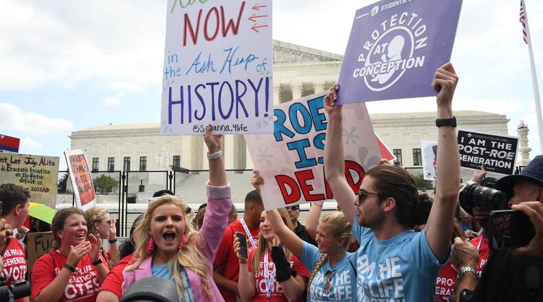 Pro-life supporters celebrate outside the US Supreme Court in Washington, DC, on June 24, 2022. - The US Supreme Court on Friday ended the right to abortion in a seismic ruling that shreds half a century of constitutional protections on one of the most divisive and bitterly fought issues in American political life. The conservative-dominated court overturned the landmark 1973 "Roe v Wade" decision that enshrined a woman's right to an abortion and said individual states can permit or restrict the procedure themselves. (OLIVIER DOULIERY/AFP via Getty Images/TNS)