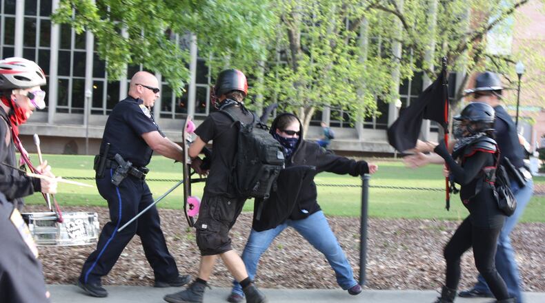 An anti-fascist counter protester clashes with Auburn police before Tuesday’s appearance by white supremacist Richard Spencer. Three people were arrested for disorderly conduct. CHRIS JOYNER / CJOYNER@AJC.COM
