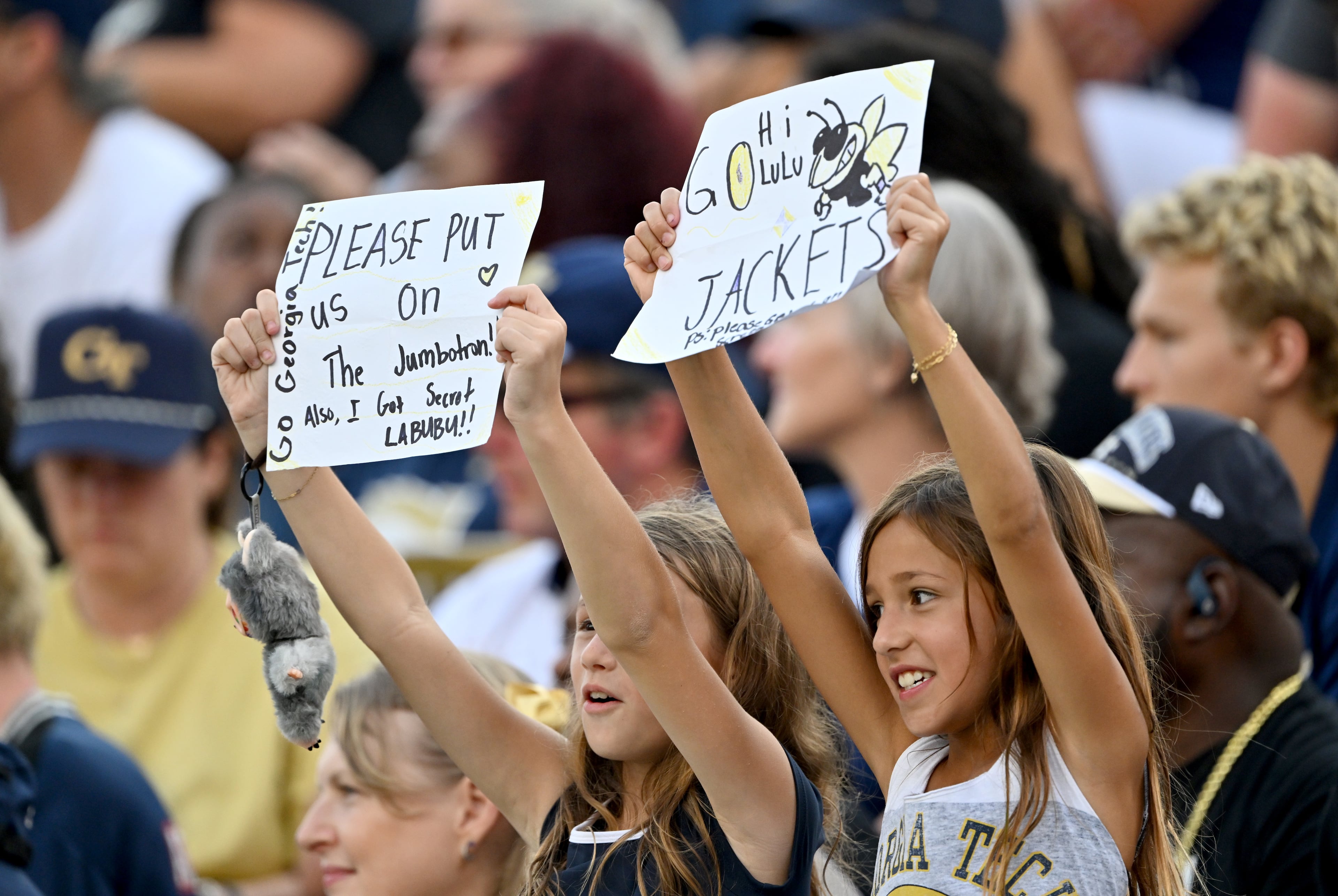 Young Georgia Tech fans hold signs during the first half of an NCAA college football game at Georgia Tech's Bobby Dodd Stadium, Saturday, Sept. 20, 2025 in Atlanta. (Hyosub Shin/AJC)