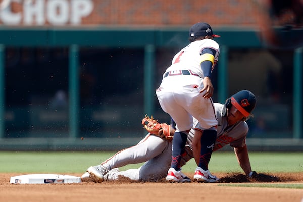 Baltimore Orioles' Jackson Holliday (7) is tagged out by Atlanta Braves second baseman Ozzie Albies (1) as he tries to steal second base during the first inning of a baseball game, Sunday, July 6, 2025, in Atlanta. (AP Photo/Butch Dill)