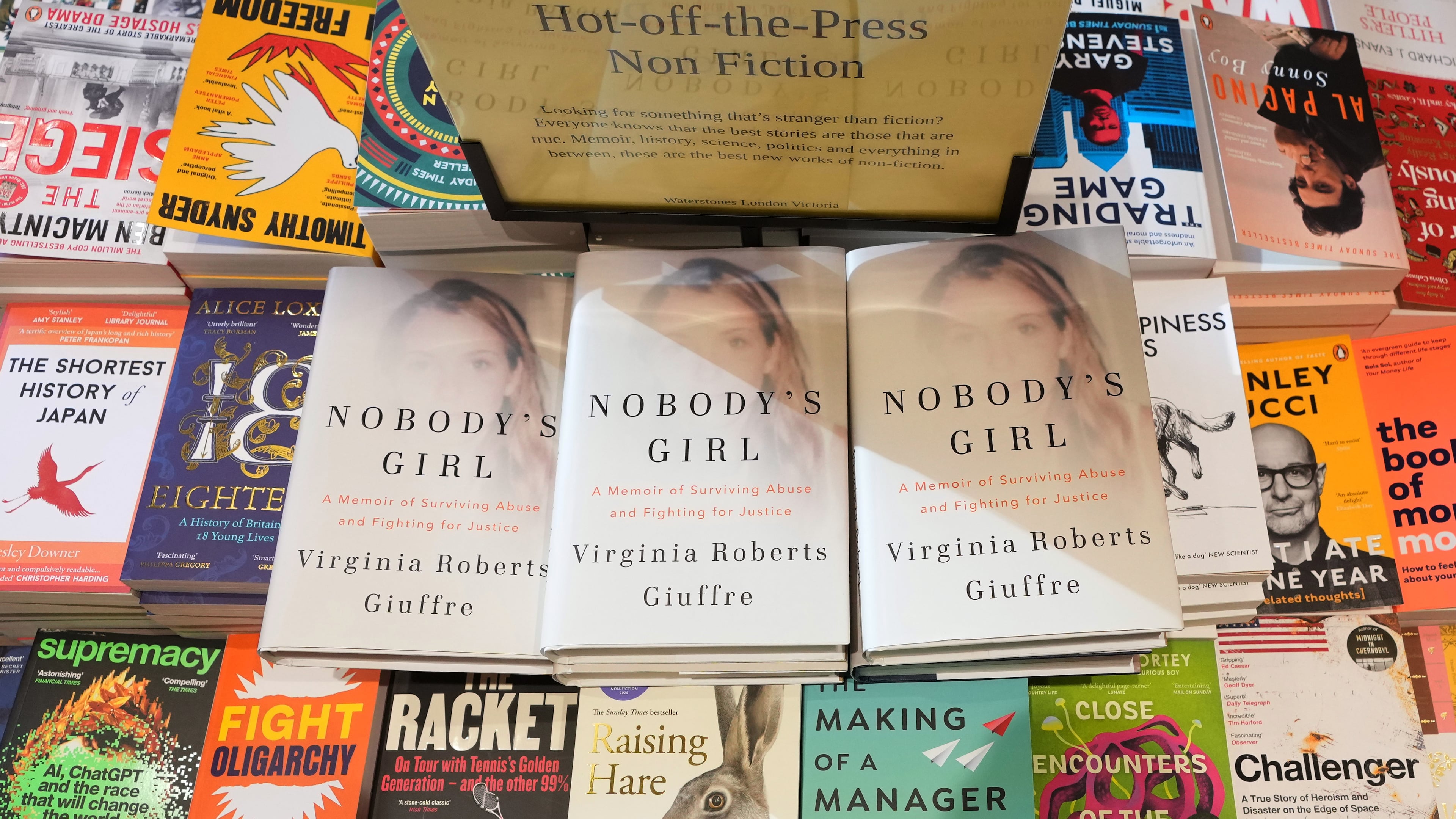 The memoir book of Virginia Giuffre, "Nobody's Girl" is seen amongst other books in a store and is up for sale in London, Tuesday, Oct. 21, 2025 six months after Giuffre died by suicide in April.(AP Photo/Kirsty Wigglesworth)